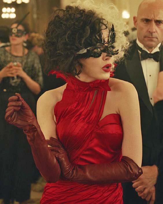 Cruella Estella in a red dress on a party
