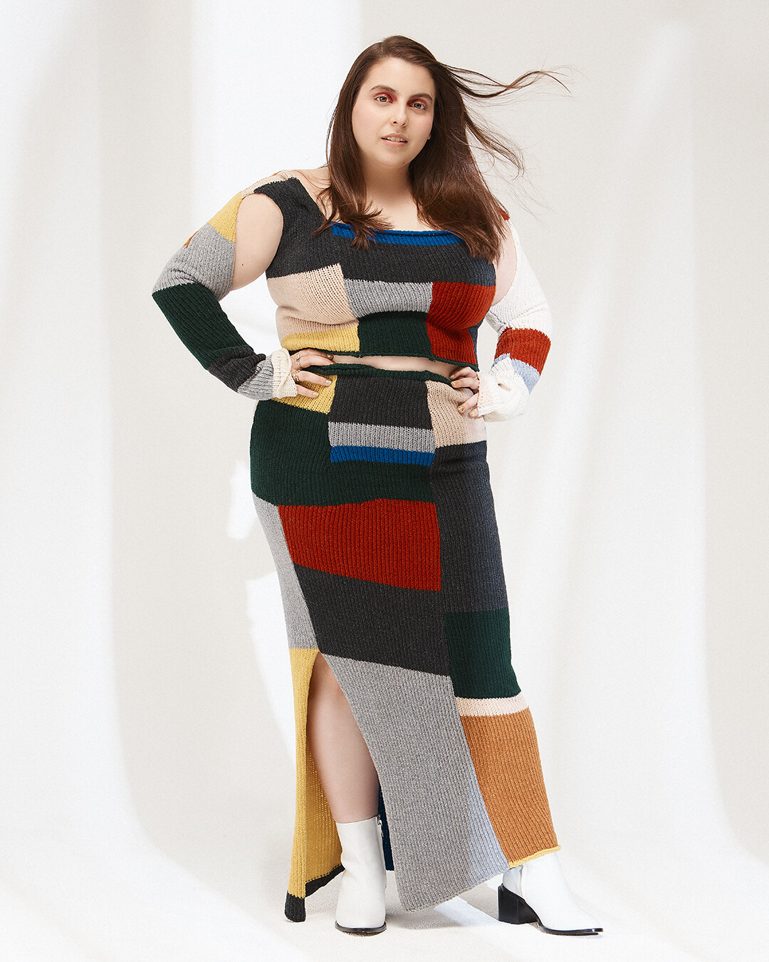 Beanie Feldstein in a kint skirt and blouse