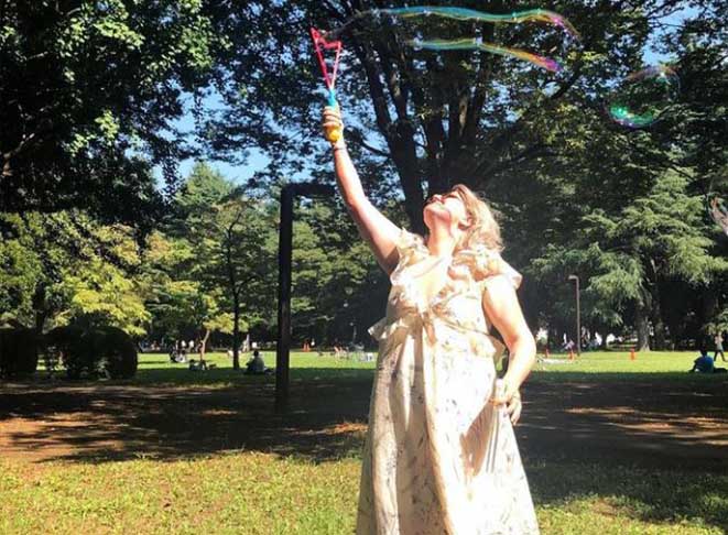 Image of Emily in Japan in a floral dress with bubbles