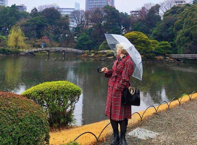 Image of Emily in Japan in a red plaid trench coat