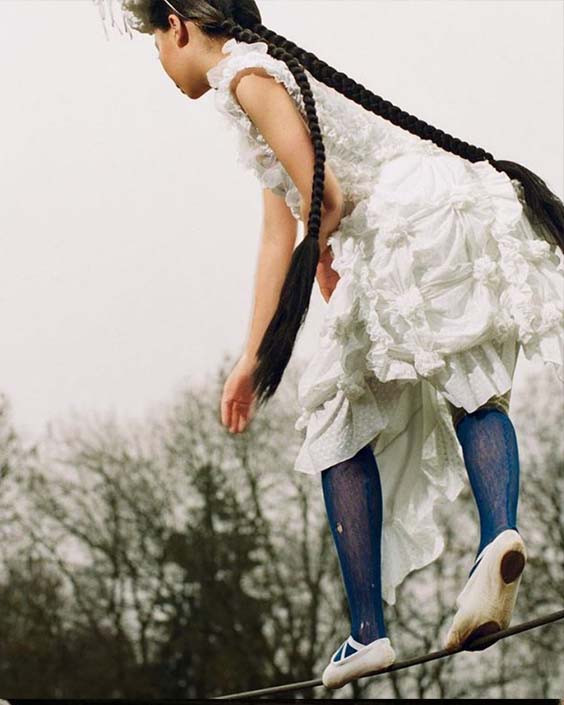 Griff in white dress with ruffles and blue tights