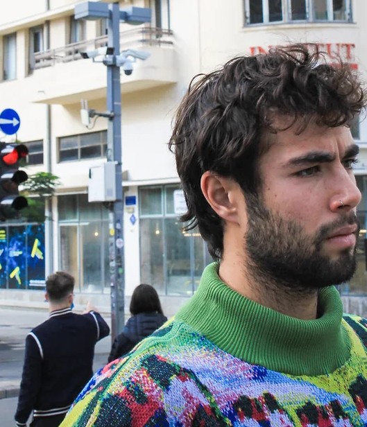 A man in a tech sweater
                