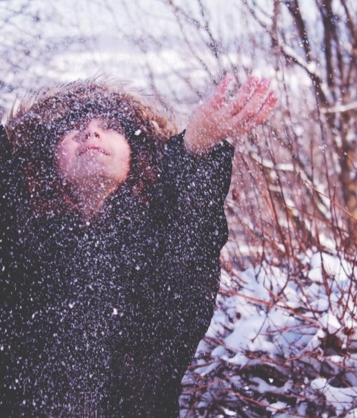 Image of a girl in snow wearing a fur jacket