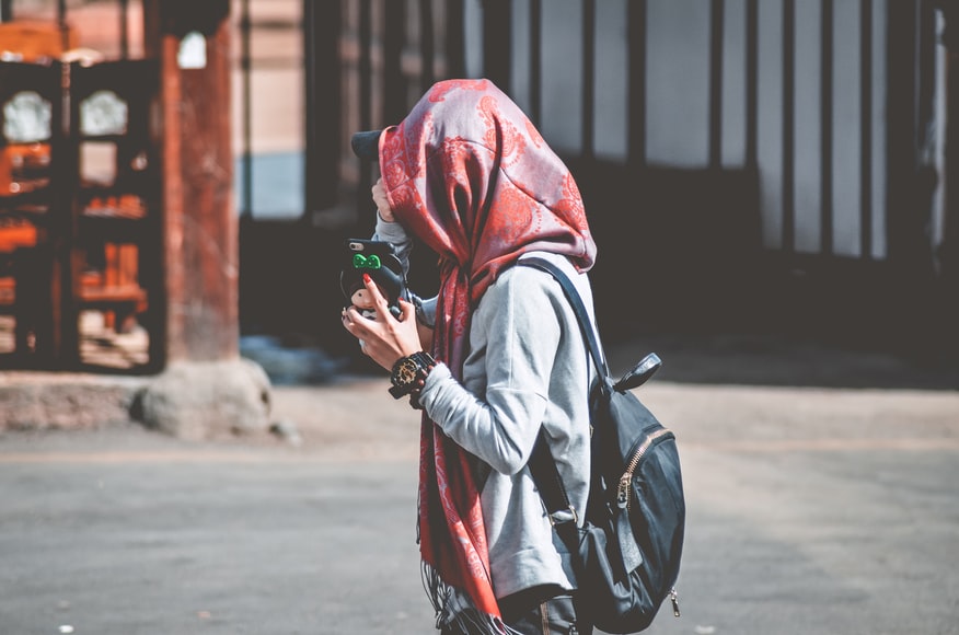 Covered girl with a red floral hijab in a hoody
