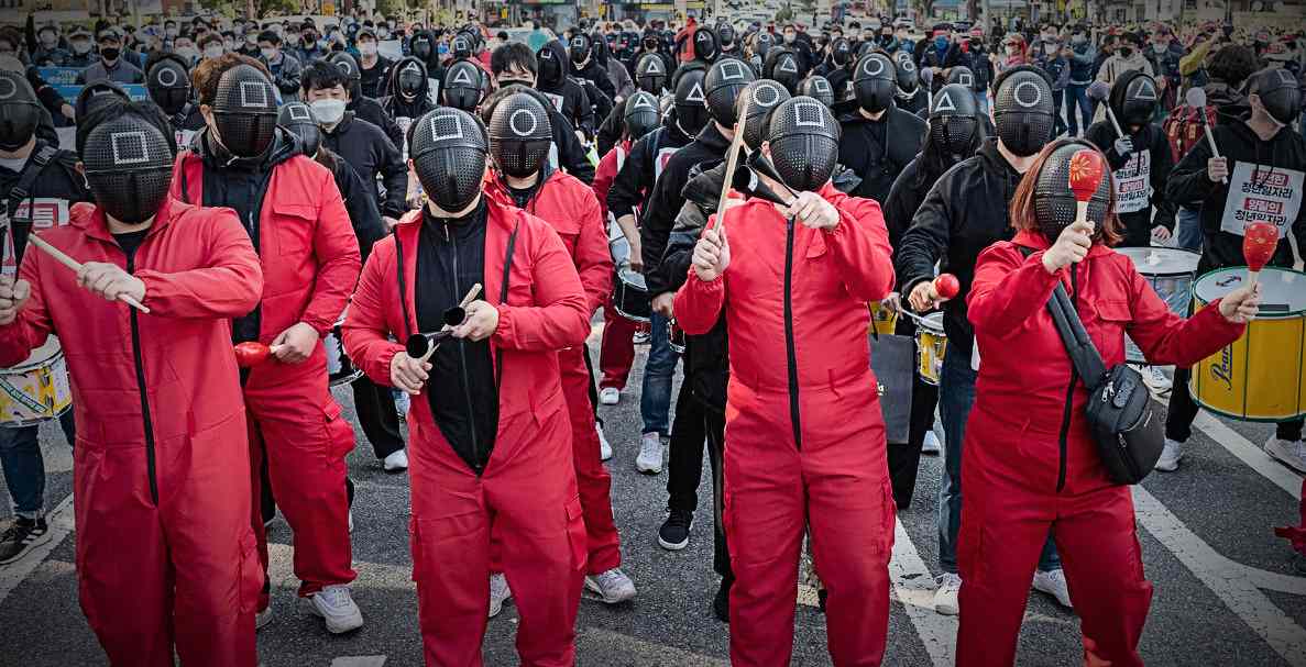 South Korean protestors wore ‘Squid Game’ masks to shine a light on poor working conditions in the country. Read the key points below.