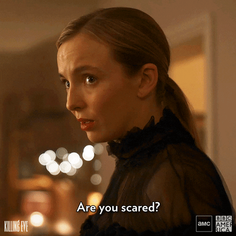 killing Eve Vilanelle gif saying are you scared in a sheer black colar dress